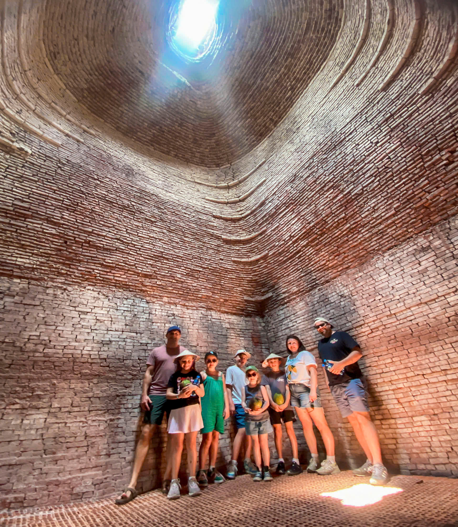 Tour group exploring a brick-making village